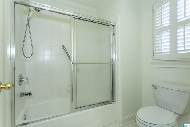 bathroom with ornamental molding, enclosed tub / shower combo, and toilet