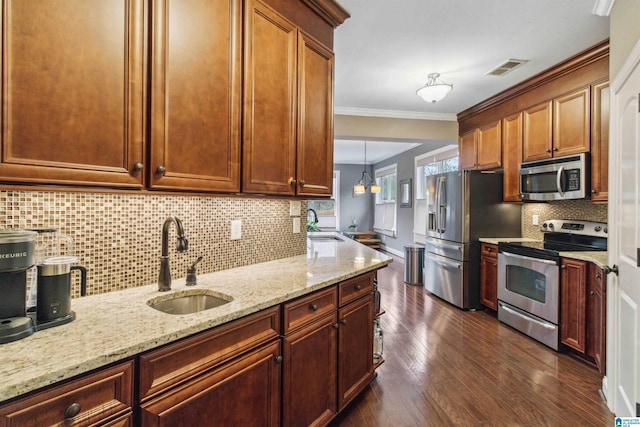 kitchen featuring sink, appliances with stainless steel finishes, light stone countertops, dark hardwood / wood-style flooring, and decorative light fixtures