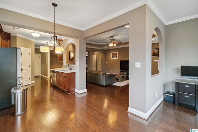 kitchen with stainless steel appliances, sink, pendant lighting, and dark hardwood / wood-style flooring