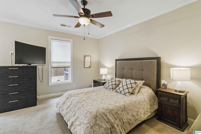 bedroom featuring light colored carpet, ornamental molding, and ceiling fan