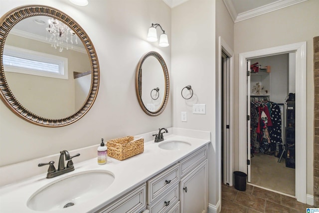 bathroom featuring a notable chandelier, ornamental molding, and vanity