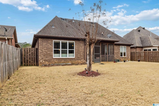 rear view of house with a yard