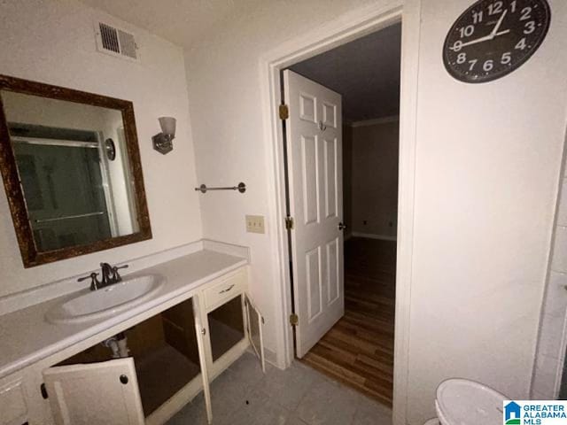 bathroom with tile patterned floors, vanity, and toilet