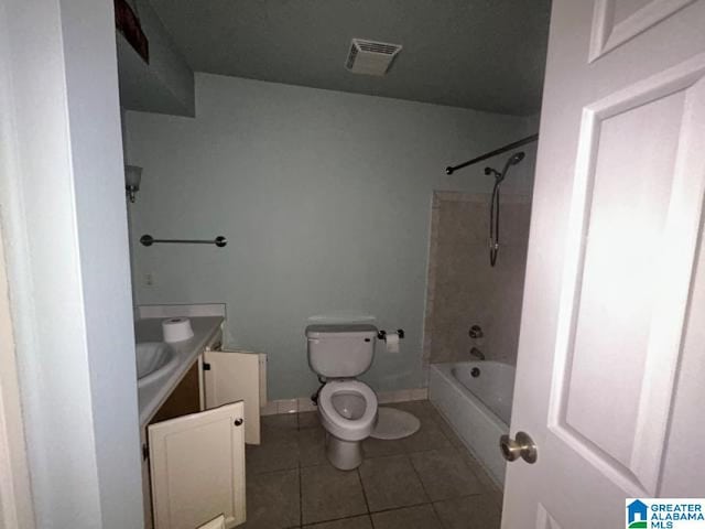 full bathroom with vanity, tiled shower / bath, tile patterned floors, and toilet