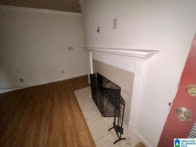 room details featuring hardwood / wood-style flooring and a tile fireplace