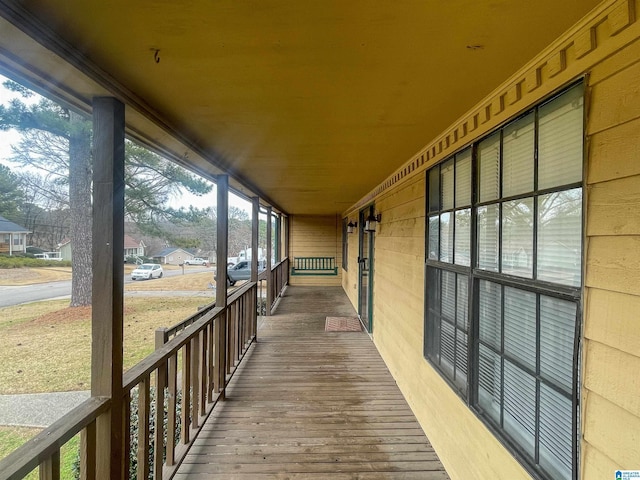 wooden terrace featuring covered porch