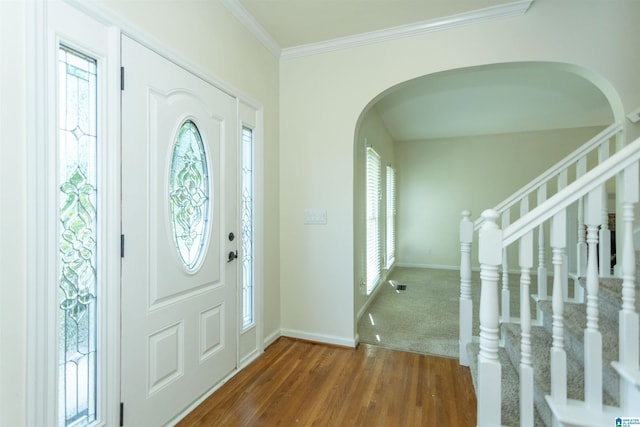 foyer entrance featuring crown molding and dark wood-type flooring