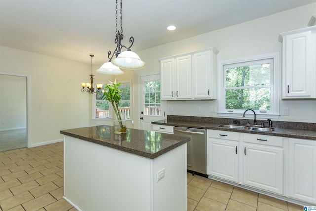 kitchen featuring dishwasher, a center island, sink, and white cabinets