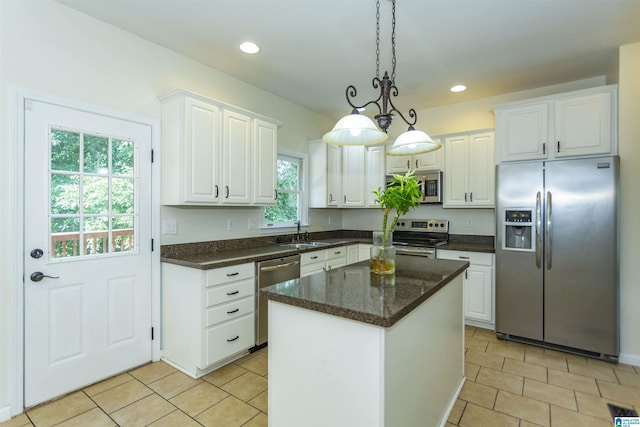 kitchen with white cabinetry, appliances with stainless steel finishes, a center island, and pendant lighting