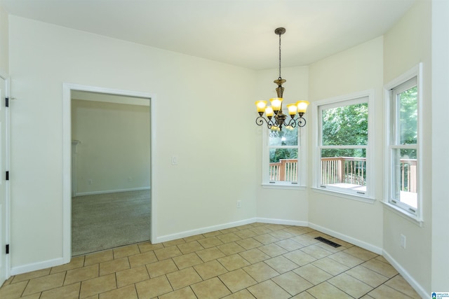 tiled empty room with a chandelier