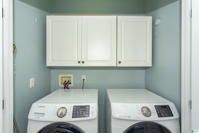 laundry room with cabinets and washer and clothes dryer