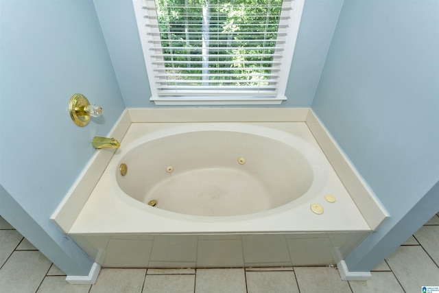 bathroom featuring tile patterned flooring and tiled bath