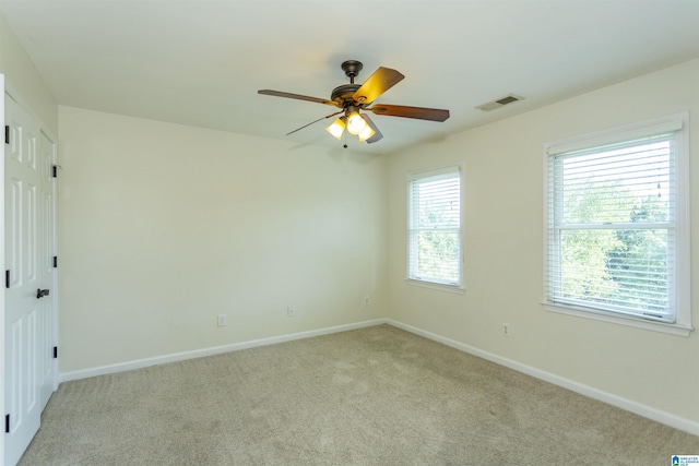 carpeted spare room with ceiling fan