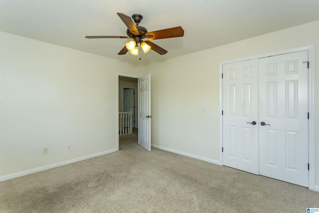 unfurnished bedroom with light carpet, ceiling fan, and a closet