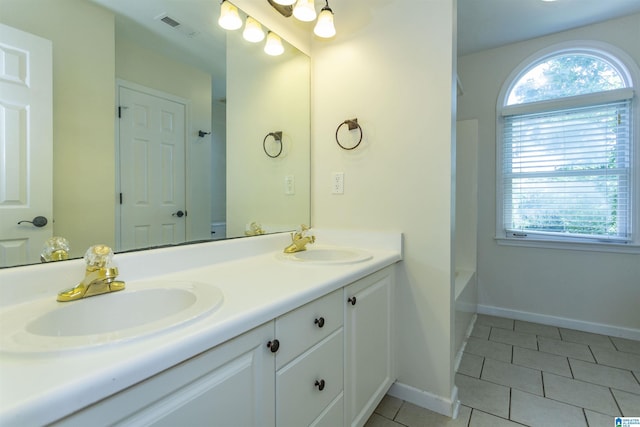 bathroom with tile patterned floors and vanity