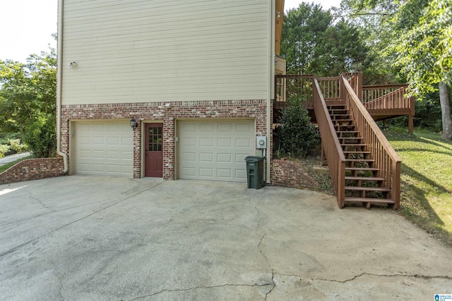 view of home's exterior with a wooden deck and a garage