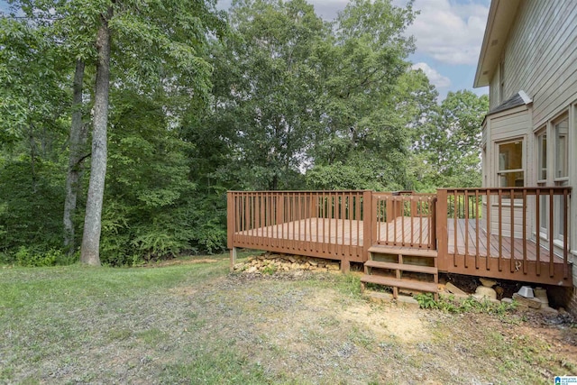 wooden deck featuring a yard