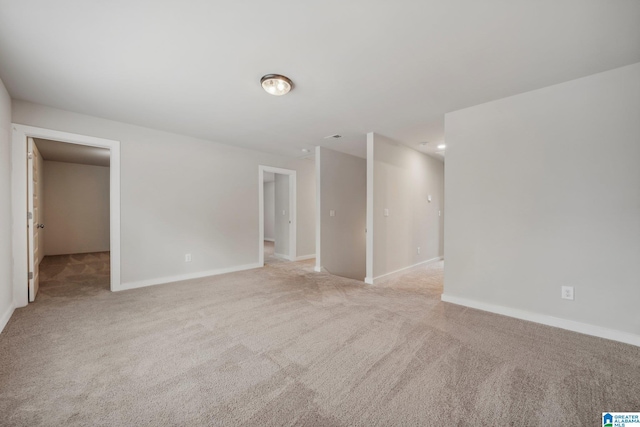 unfurnished room featuring light carpet