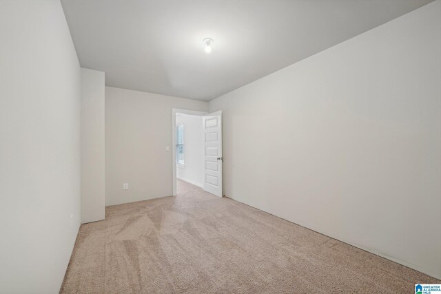 empty room featuring light colored carpet