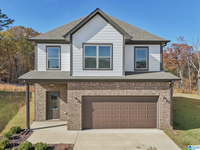 view of front of home featuring a garage and a front yard