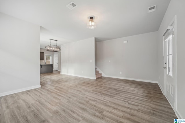 unfurnished living room with light hardwood / wood-style floors