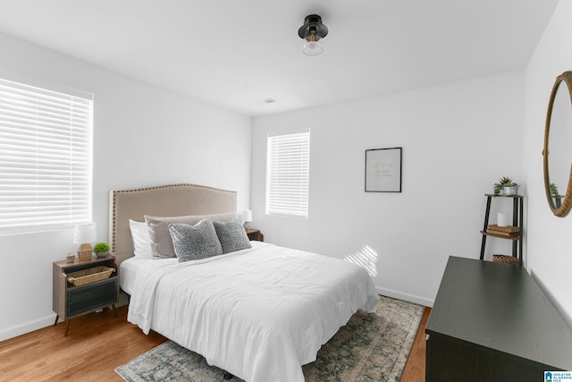 bedroom with wood-type flooring