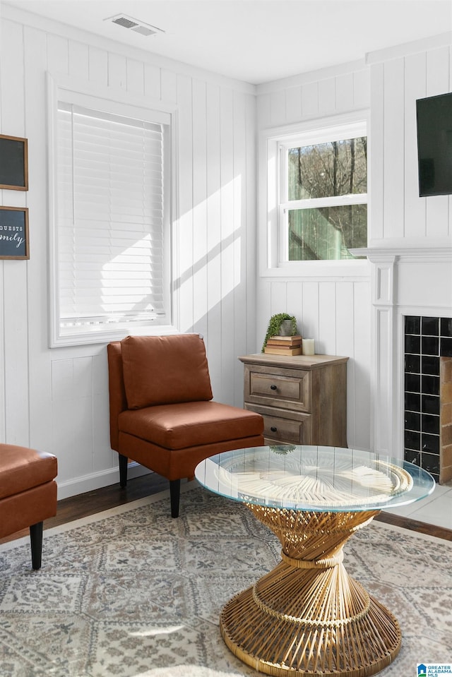 sitting room with wood-type flooring and a fireplace