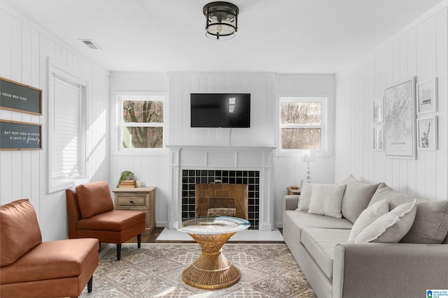 living room featuring a tiled fireplace