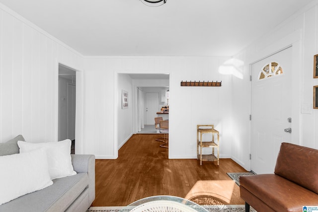 living room featuring hardwood / wood-style flooring and crown molding