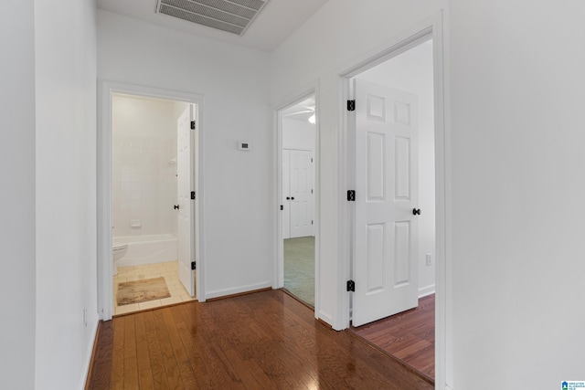 corridor with dark hardwood / wood-style floors