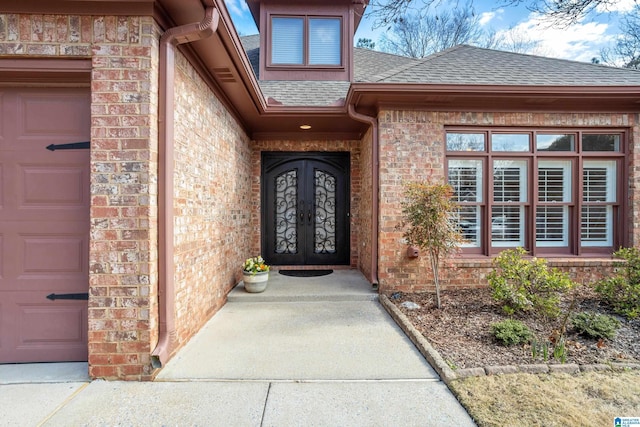 doorway to property featuring french doors and a garage