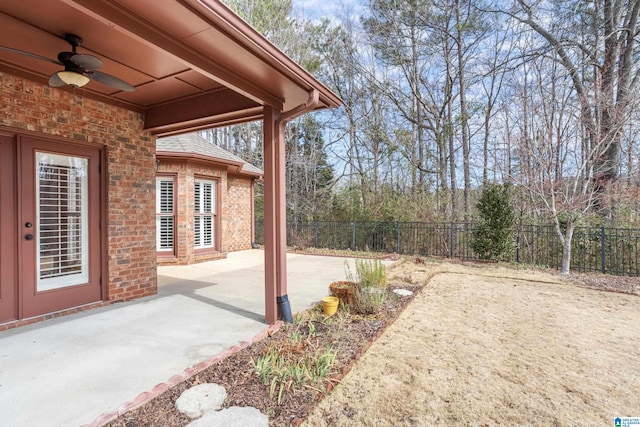 view of yard featuring a patio area and ceiling fan