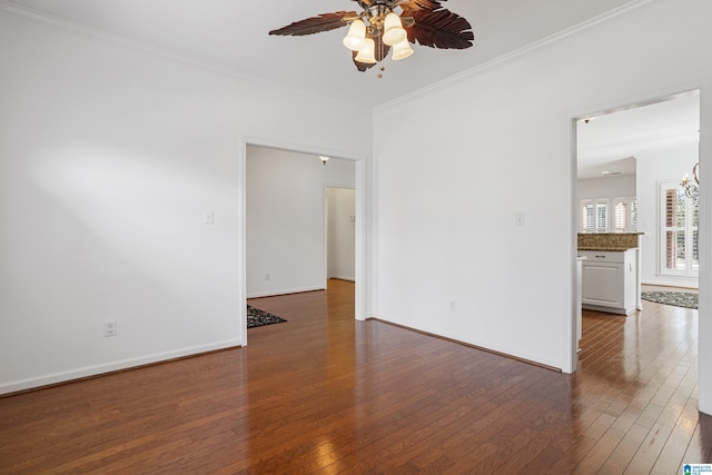 spare room featuring ornamental molding, dark hardwood / wood-style floors, and ceiling fan