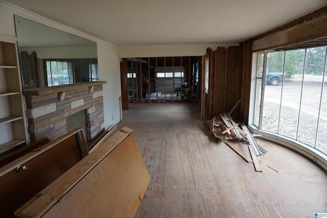 unfurnished living room featuring hardwood / wood-style flooring and ornamental molding