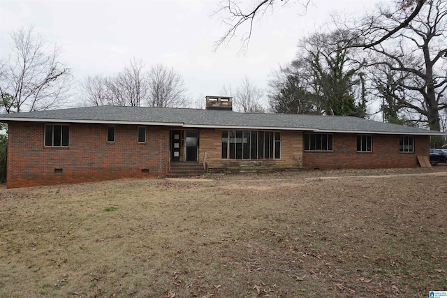 rear view of property featuring a lawn