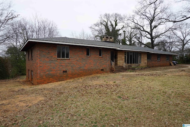 back of property featuring a lawn