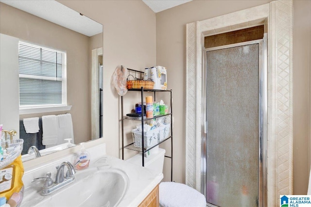 bathroom with walk in shower, vanity, and toilet