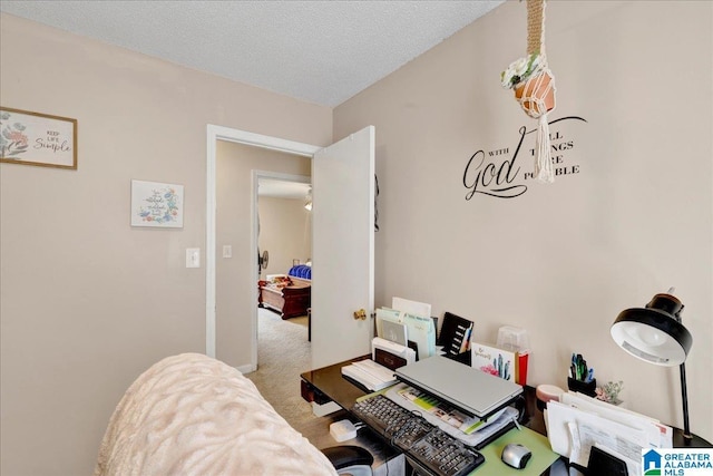 home office featuring carpet and a textured ceiling