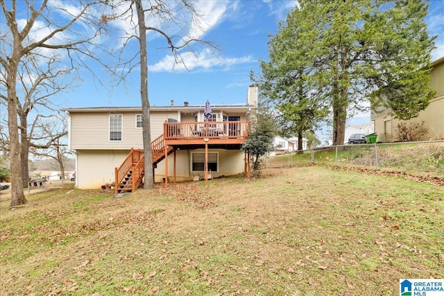 rear view of property featuring a yard and a deck