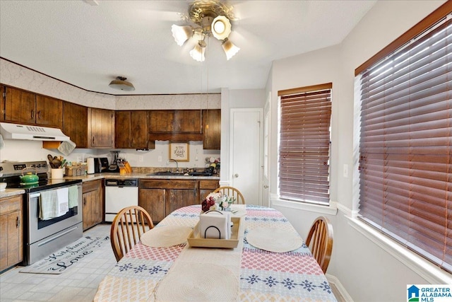 kitchen featuring ceiling fan, sink, stainless steel range with electric cooktop, and white dishwasher