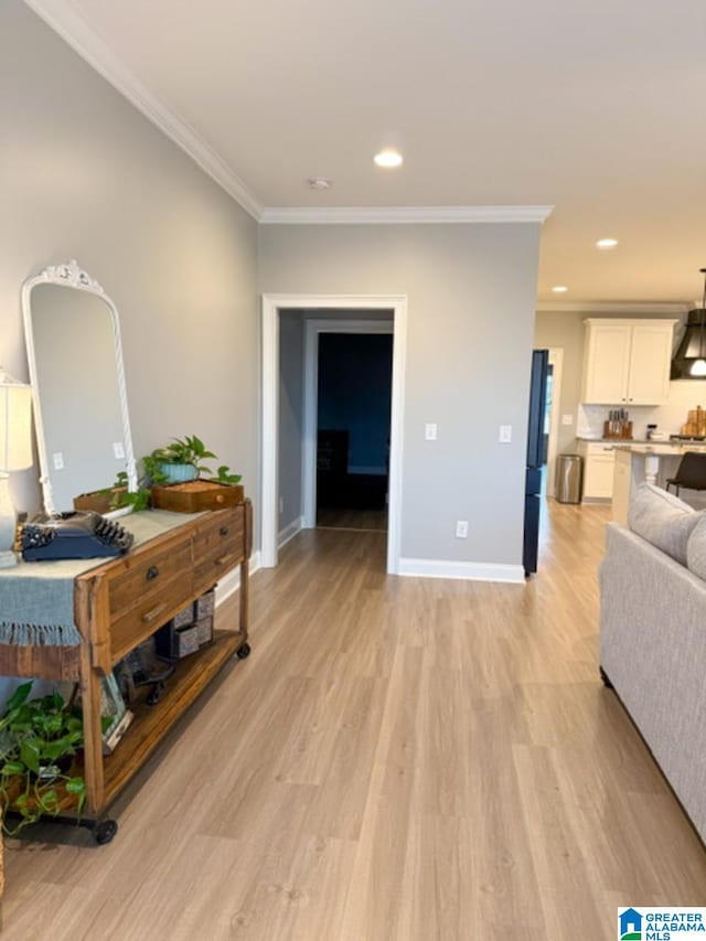 interior space featuring crown molding and light wood-type flooring