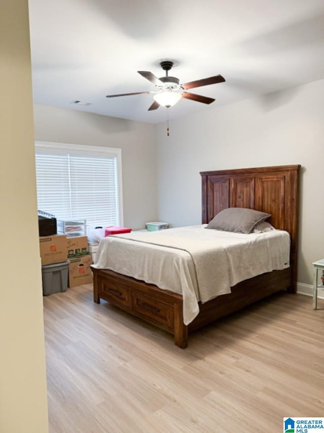 bedroom with light hardwood / wood-style floors and ceiling fan