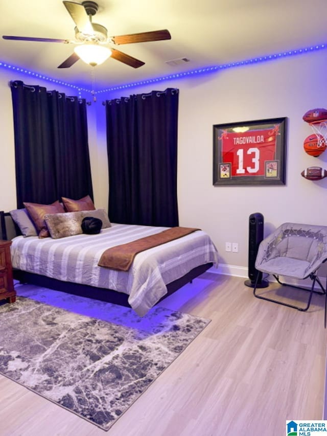 bedroom with hardwood / wood-style flooring and ceiling fan