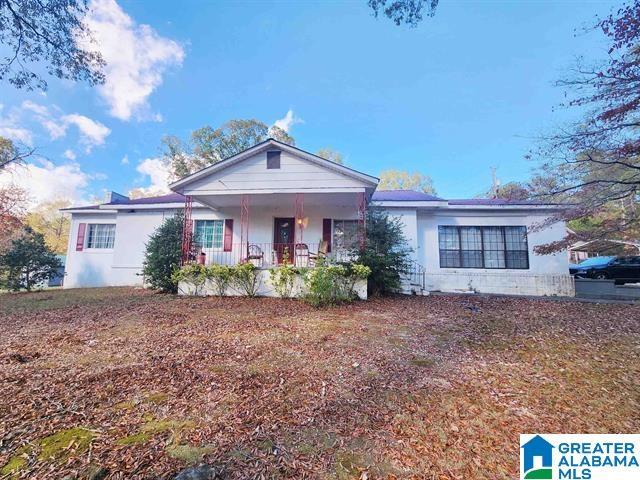 single story home featuring covered porch