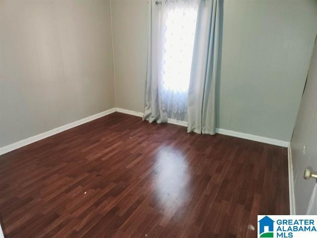 unfurnished room with dark hardwood / wood-style floors