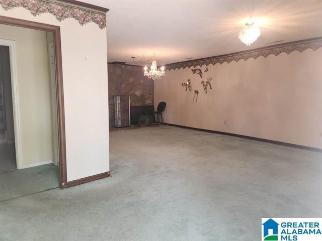 unfurnished living room with carpet floors and a chandelier