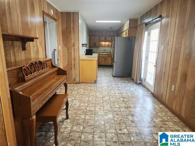 miscellaneous room featuring sink and wood walls