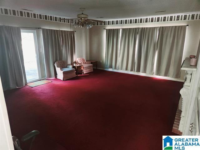 living area with ceiling fan and carpet floors