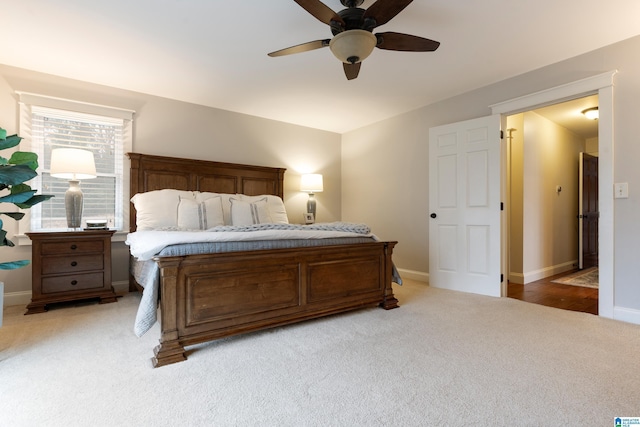 bedroom featuring light carpet and ceiling fan