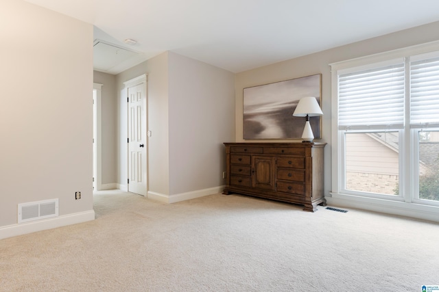 spare room featuring light colored carpet